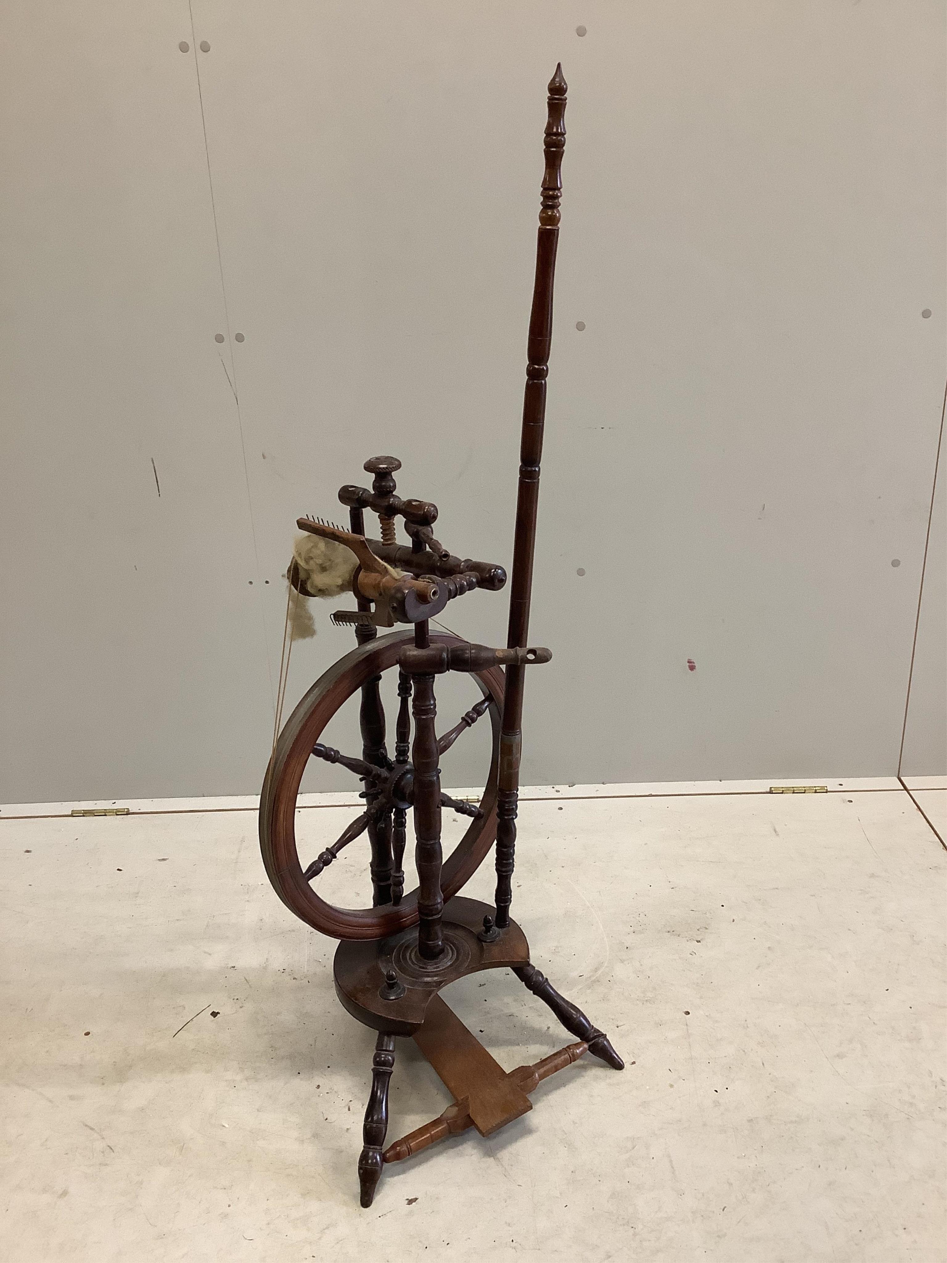 Two 19th century spinning wheels, larger height 124cm. Condition - fair